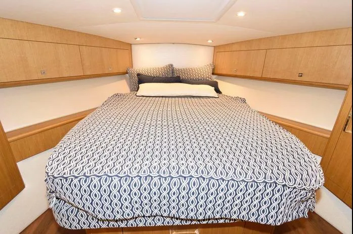 Slide: The Image of Luxurious cabin interior of 2015 Hatteras 45 Express Sportfish with patterned bedding. - 9