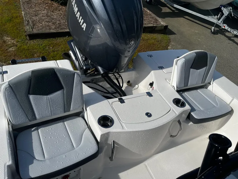 Slide: The Image of 2025 Robalo 206 Cayman boat interior with Yamaha engine, featuring wet seating and storage. - 13