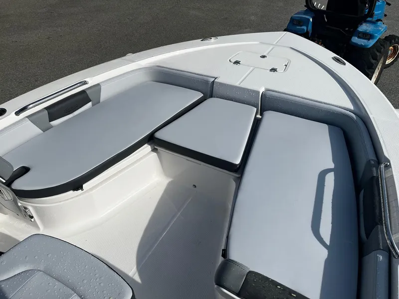 Slide: The Image of 2025 Robalo 206 Cayman boat interior with cushioned seating and storage compartments. - 19
