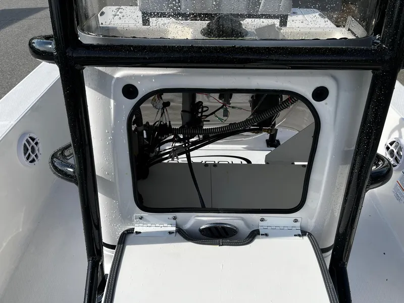 Slide: The Image of 2025 Robalo 206 Cayman boat interior showing open storage compartment with visible wiring. - 2