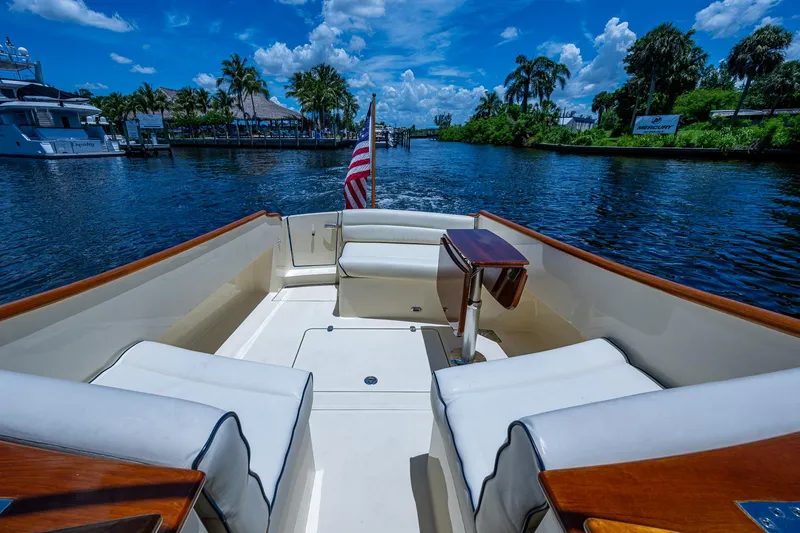 Slide: The Image of Hinckley Talaria 34 boat interior, 2016 model, cruising on a scenic waterway with palm trees. - 13