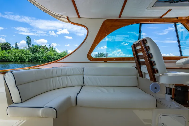 Slide: The Image of Interior of 2016 Hinckley Talaria 34 yacht with white seating and wooden accents. - 5