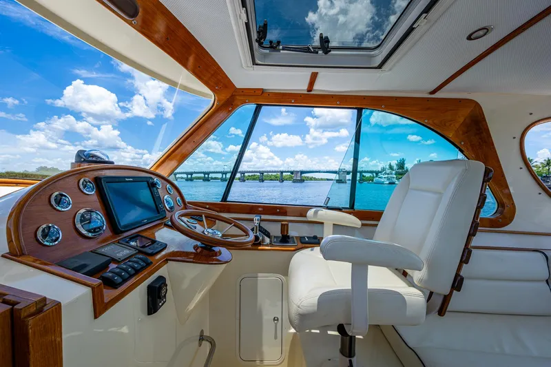 Slide: The Image of Interior of 2016 Hinckley Talaria 34 yacht with helm, steering wheel, and scenic water view. - 6