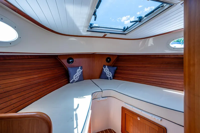Slide: The Image of Interior of 2016 Hinckley Talaria 34 yacht with wooden paneling and skylight. - 11