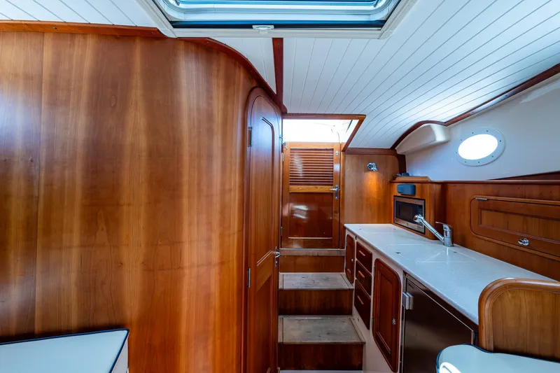 Slide: The Image of Interior of 2016 Hinckley Talaria 34 yacht with wooden cabinetry and modern kitchen amenities. - 9