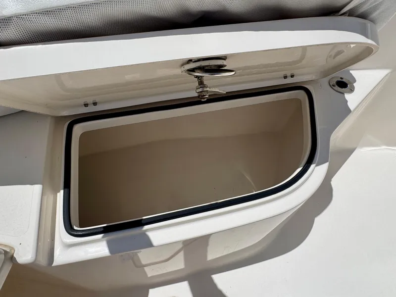 Slide: The Image of Open storage compartment on 2022 Cobia 237 Center Console boat. - 11
