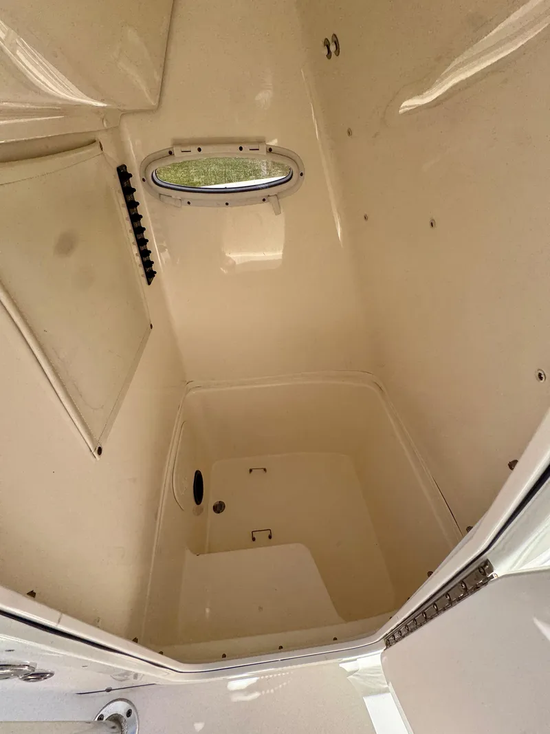 Slide: The Image of Interior of 2022 Cobia 237 Center Console boat, featuring a compact storage compartment. - 13