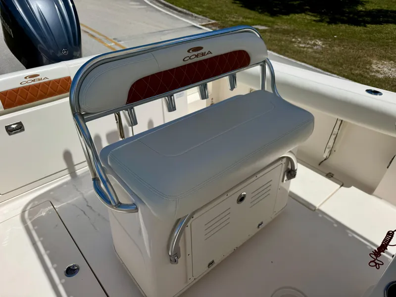 Slide: The Image of 2022 Cobia 237 Center Console boat seating with storage and rod holders. - 14