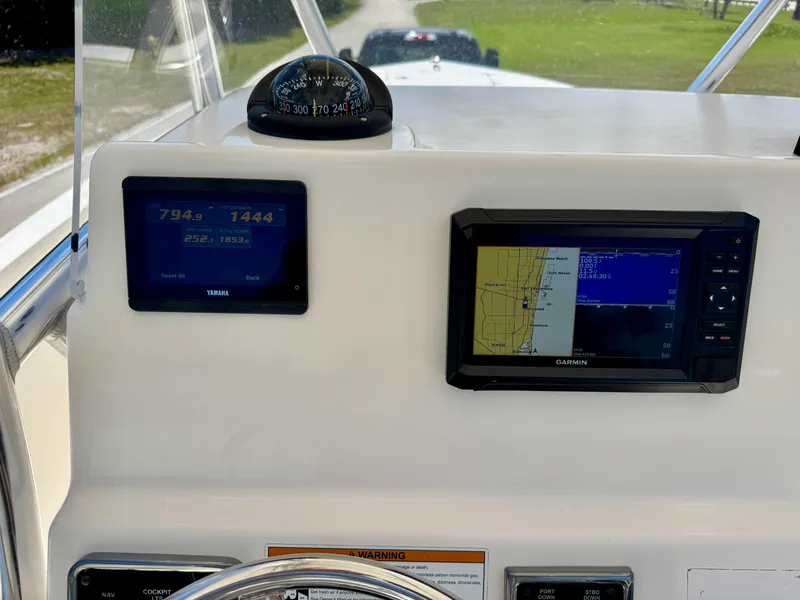 Slide: The Image of 2022 Cobia 237 Center Console dashboard with Yamaha and Garmin displays. - 18