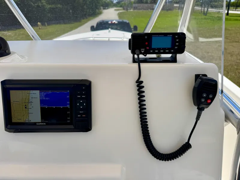 Slide: The Image of 2022 Cobia 237 Center Console dashboard with Garmin navigation and radio equipment. - 19