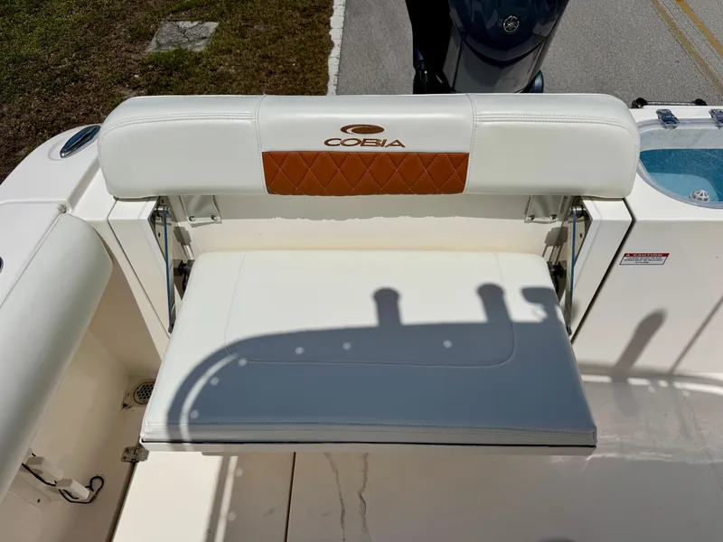 Slide: The Image of 2022 Cobia 237 Center Console boat seat with logo and cushion detail. - 21