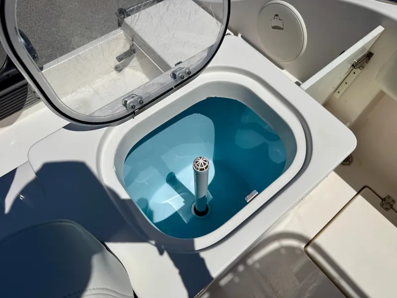 Slide: The Image of Livewell on a 2022 Cobia 237 Center Console boat, open lid, blue interior. - 22