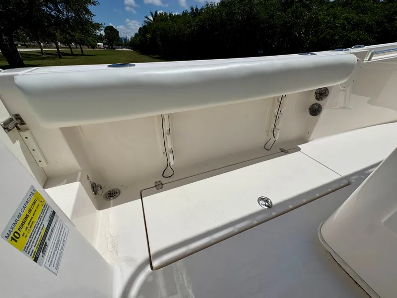 Slide: The Image of 2022 Cobia 237 Center Console boat interior with seating and storage compartments. - 23