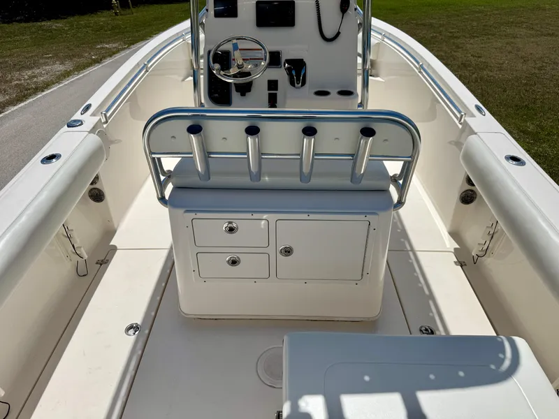 Slide: The Image of 2022 Cobia 237 Center Console boat interior with rod holders and storage compartments. - 26
