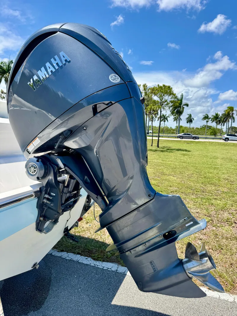 Slide: The Image of Yamaha outboard motor on 2022 Cobia 237 Center Console boat, sunny day, palm trees. - 27
