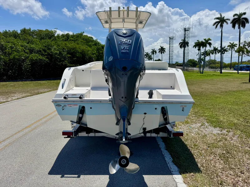 Slide: The Image of 2022 Cobia 237 Center Console boat with Yamaha 250 V6 engine on a sunny day. - 3