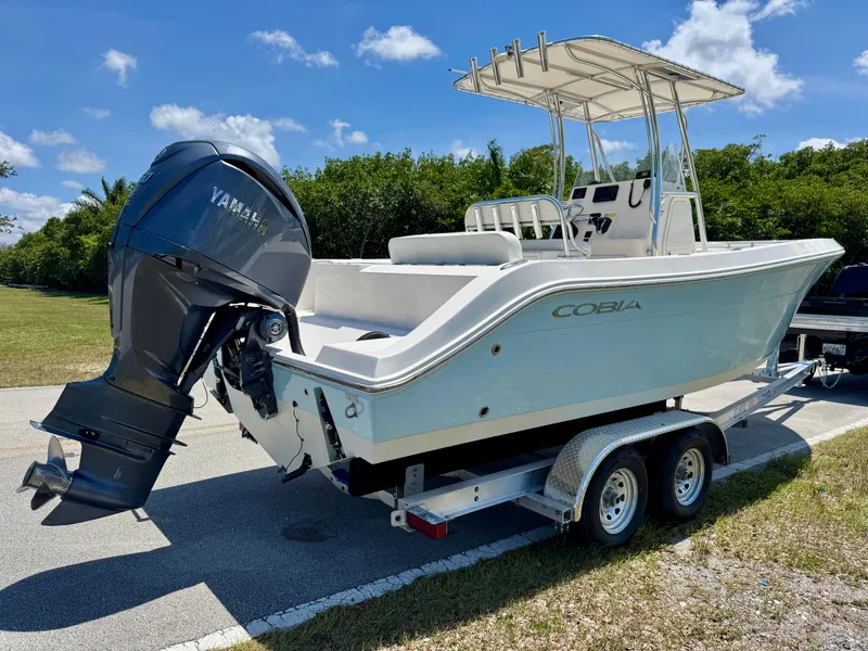 Slide: The Image of 2022 Cobia 237 Center Console boat on trailer with Yamaha outboard motor. - 4