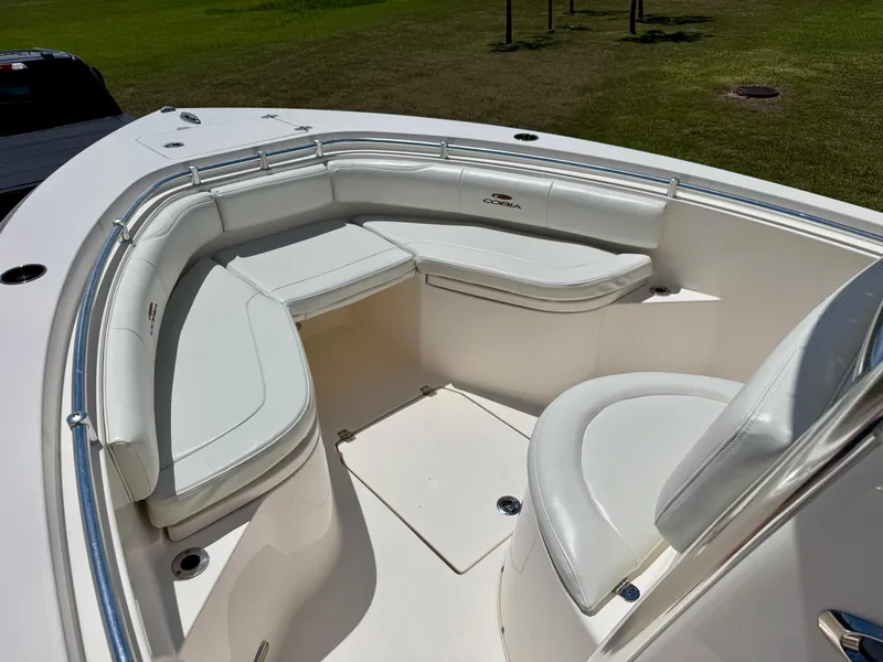Slide: The Image of 2022 Cobia 237 Center Console boat with white cushioned seating area. - 7