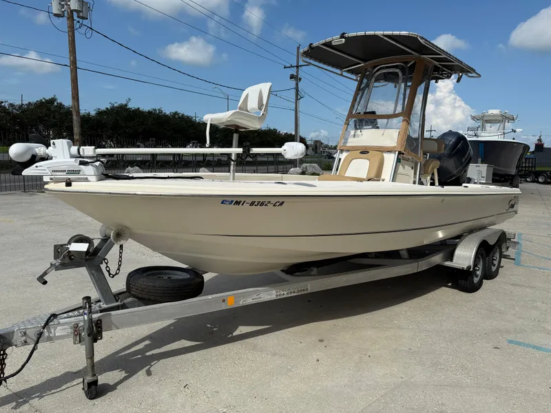 Slide: The Image of 2014 Scout WINYAH BAY 221 boat on trailer, parked outdoors under clear sky. - 4