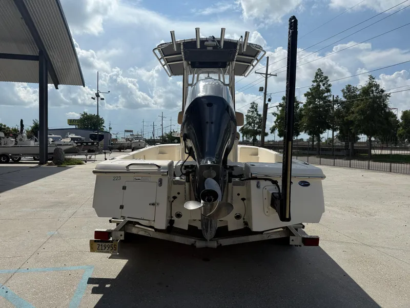 Slide: The Image of 2014 Scout WINYAH BAY 221 boat, rear view, parked outdoors under a cloudy sky. - 6