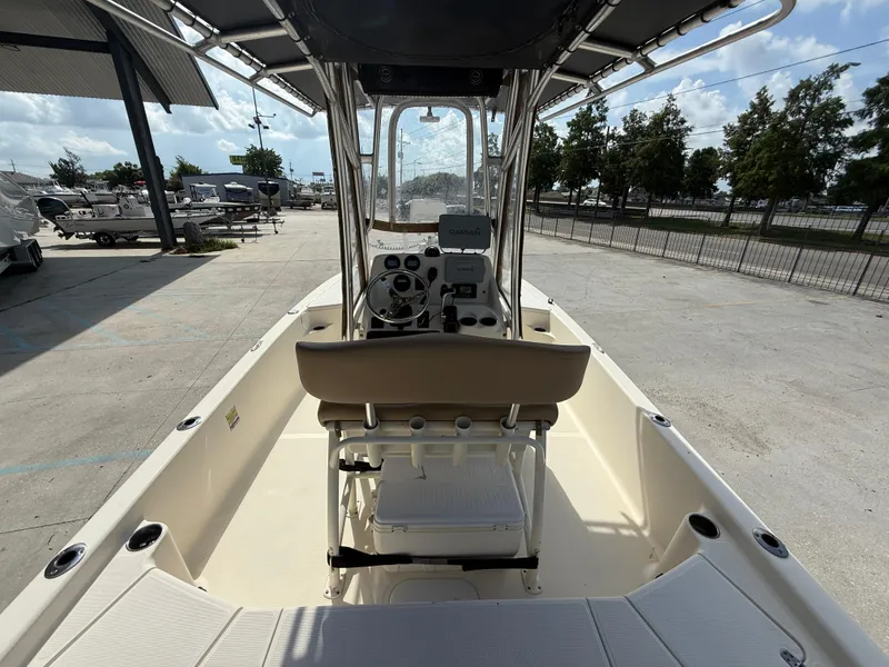 Slide: The Image of 2014 Scout WINYAH BAY 221 boat interior with steering console and seating, parked outdoors. - 8