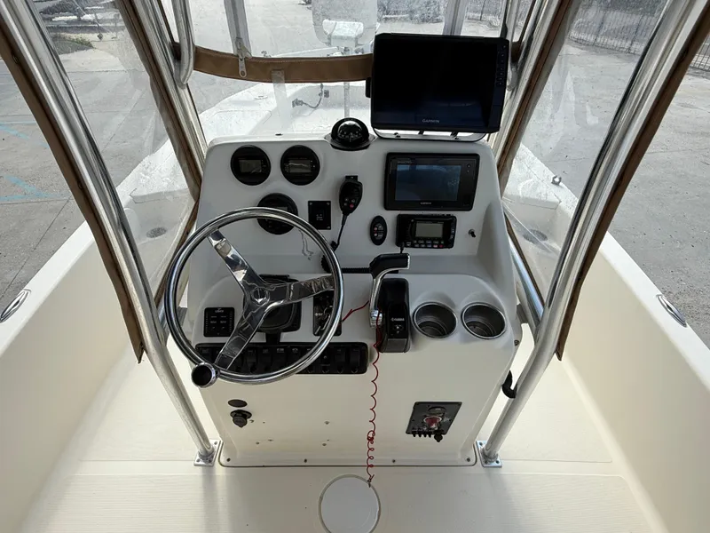 Slide: The Image of 2014 Scout WINYAH BAY 221 boat console with steering wheel and navigation equipment. - 9