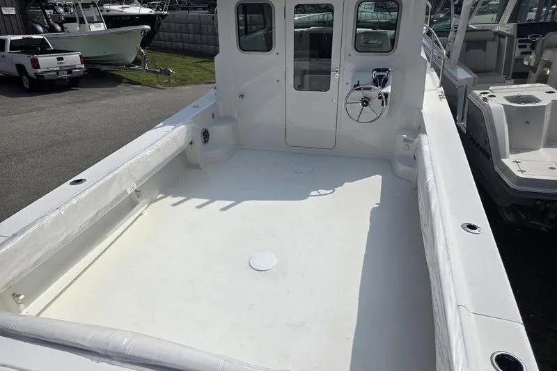 Slide: The Image of 2025 Parker 2820 XLD boat deck with steering wheel and spacious layout. - 10