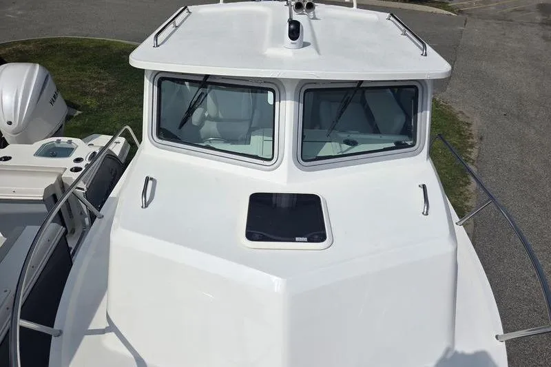 Slide: The Image of 2025 Parker 2820 XLD boat, white exterior, front view with windows and railing. - 13