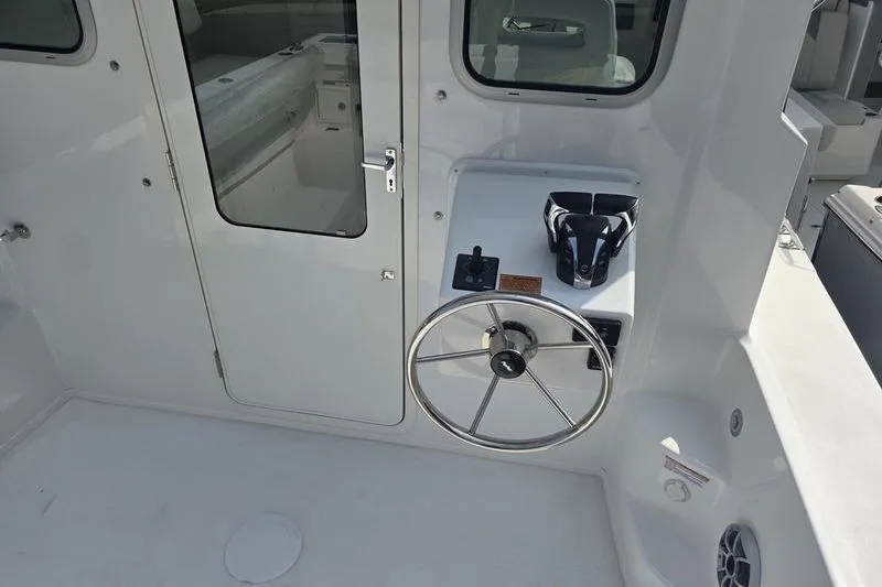 Slide: The Image of 2025 Parker 2820 XLD boat cockpit with steering wheel and control panel. - 14