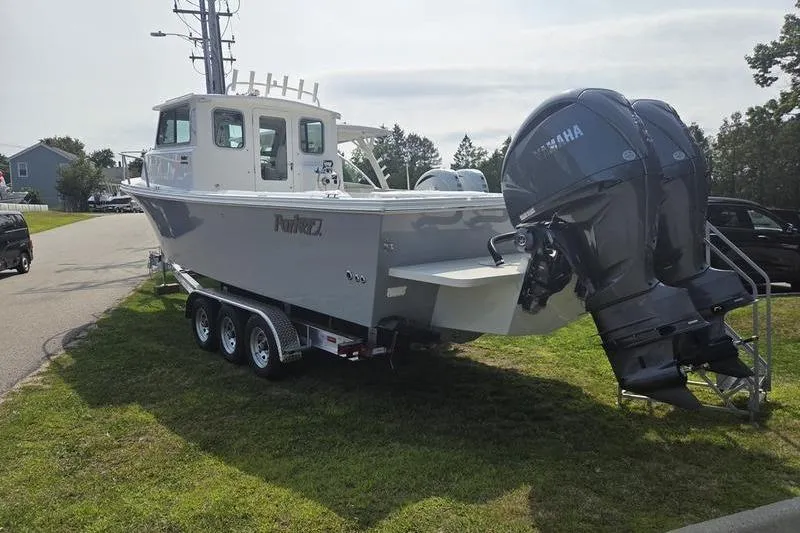 Slide: The Image of 2025 Parker 2820 XLD boat on trailer with dual Yamaha outboard motors. - 5