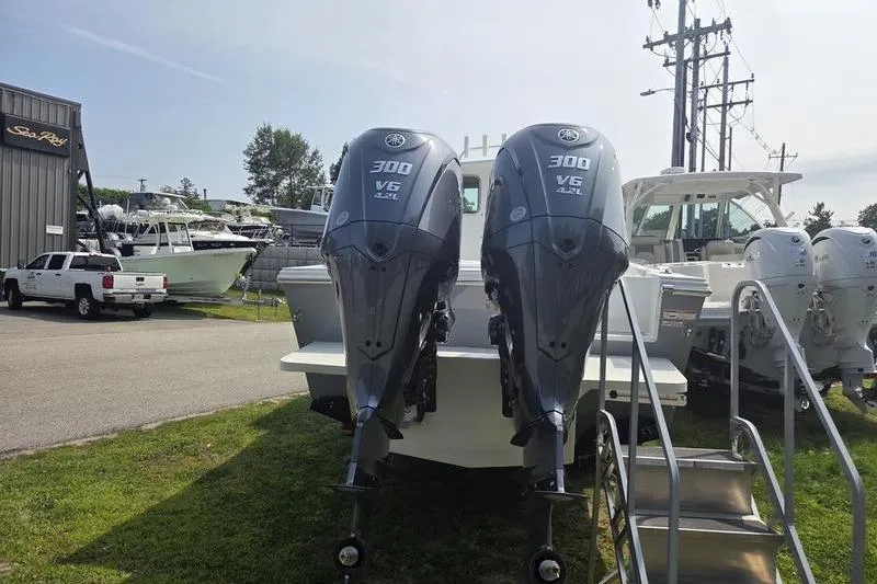 Slide: The Image of 2025 Parker 2820 XLD boat with twin 300 V6 outboard engines displayed outdoors. - 8