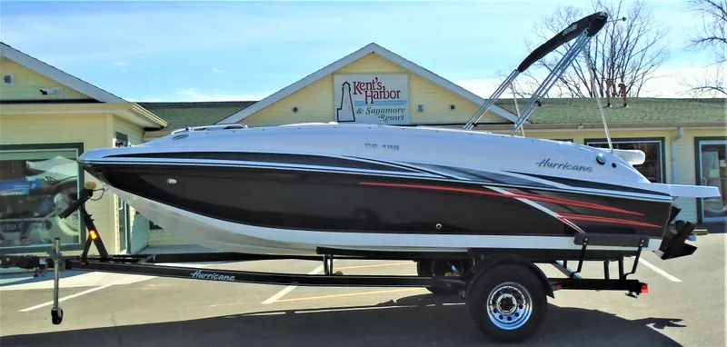 The Image of 2019 Hurricane SS188 boat on trailer outside a building, featuring sleek black and white design. - 1