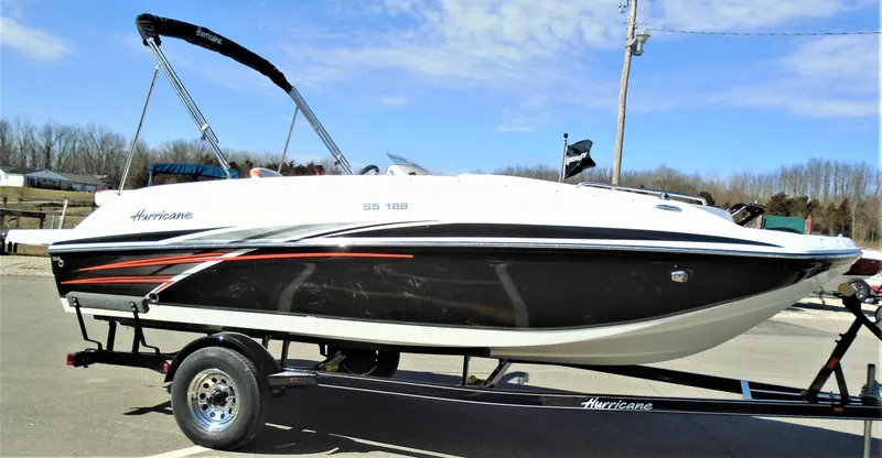 Slide: The Image of 2019 Hurricane SS188 boat on trailer, black and white design, parked outdoors. - 2