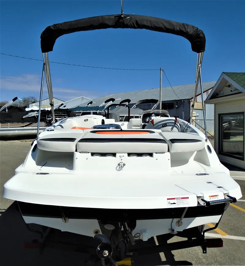 Slide: The Image of 2019 Hurricane SS188 boat with canopy, docked at a marina under clear blue skies. - 4