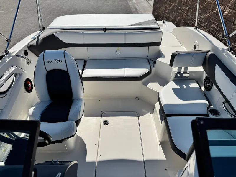 Slide: The Image of 2015 Sea Ray 19 SPX boat interior with white seating and steering wheel. - 10