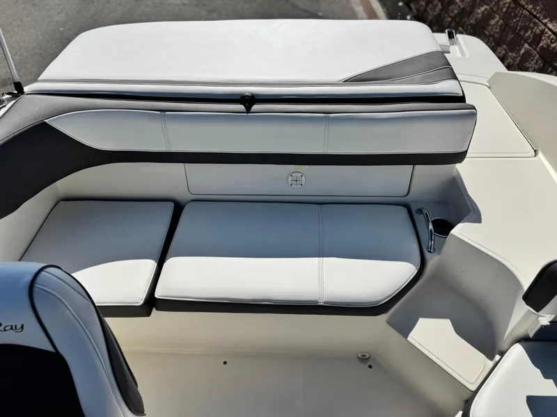 Slide: The Image of 2015 Sea Ray 19 SPX boat interior with white seating and cup holder. - 11