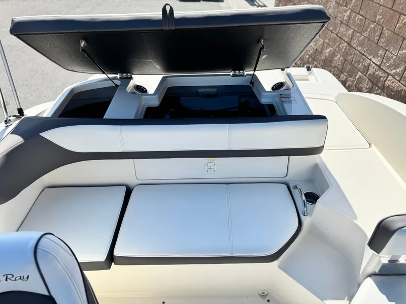 Slide: The Image of 2015 Sea Ray 19 SPX boat interior with open storage compartment and seating. - 12