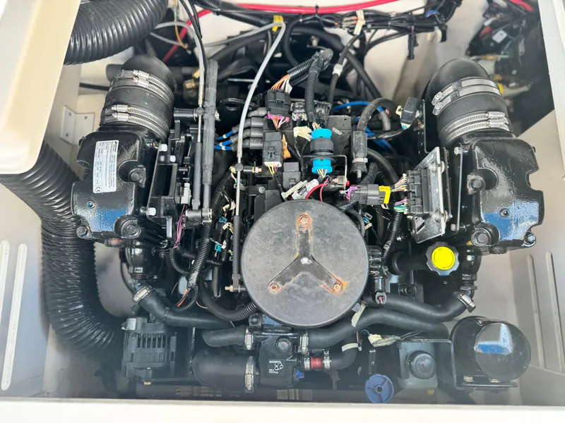 Slide: The Image of Engine compartment of a 2015 Sea Ray 19 SPX boat, showcasing detailed components. - 13