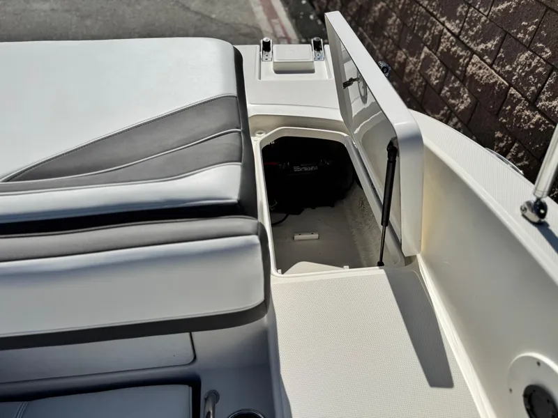 Slide: The Image of 2015 Sea Ray 19 SPX boat interior storage compartment with open hatch. - 17