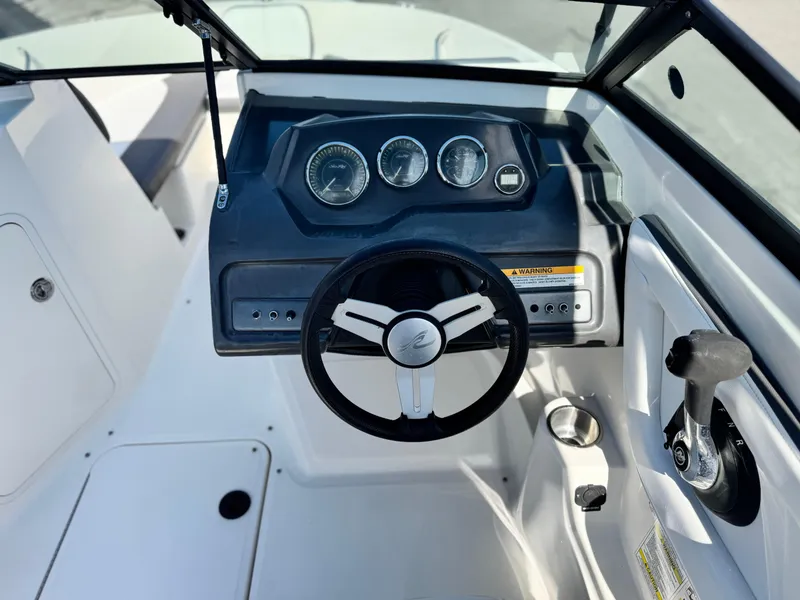 Slide: The Image of 2015 Sea Ray 19 SPX boat dashboard with steering wheel and control panel. - 20