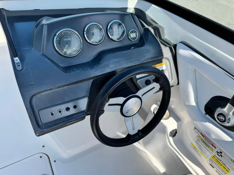 Slide: The Image of 2015 Sea Ray 19 SPX boat dashboard with steering wheel and gauges. - 21