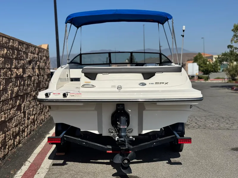 Slide: The Image of 2015 Sea Ray 19 SPX boat with blue canopy, rear view on trailer. - 4