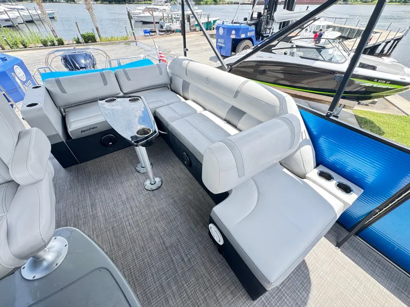 Slide: The Image of 2019 AquaPatio 259 DFL pontoon boat with spacious seating and sleek design by the water. - 10