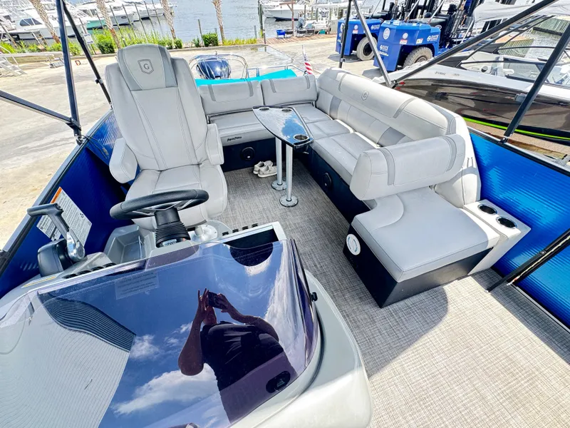 Slide: The Image of 2019 AquaPatio 259 DFL boat interior with plush seating and modern helm. - 4