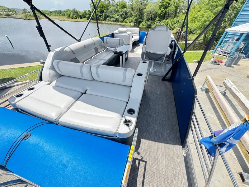 Slide: The Image of 2019 AquaPatio 259 DFL pontoon boat with spacious seating and scenic lake view. - 5