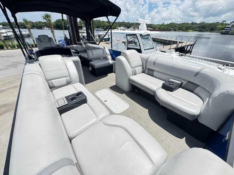 Slide: The Image of 2019 AquaPatio 259 DFL boat interior with luxurious seating and waterfront view. - 7