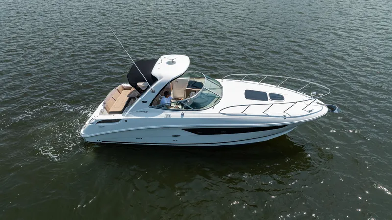 Slide: The Image of 2016 Sea Ray 310 Sundancer cruising on open water, side view. - 10