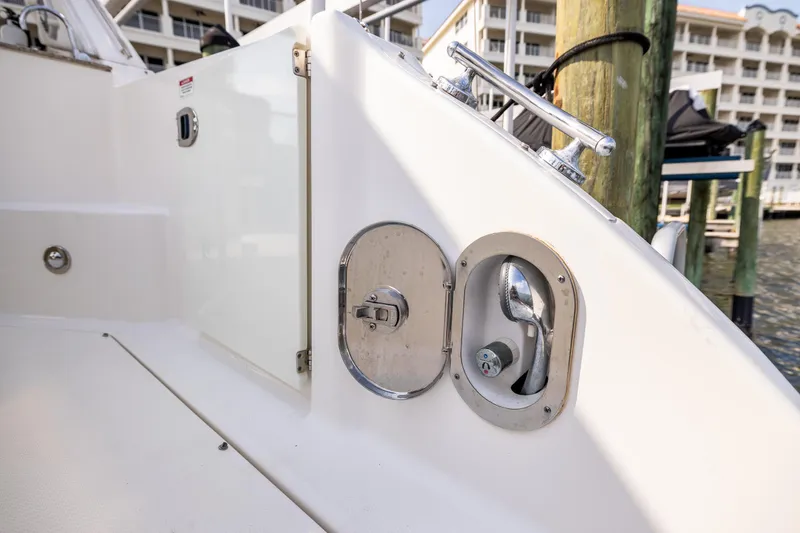 Slide: The Image of 2016 Sea Ray 310 Sundancer boat deck with water hose compartment. - 21