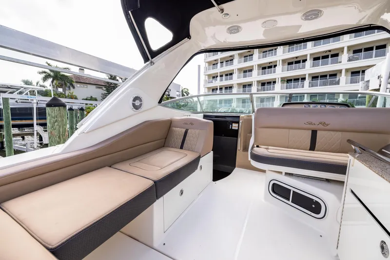 Slide: The Image of 2016 Sea Ray 310 Sundancer interior with beige seating and modern design. - 27