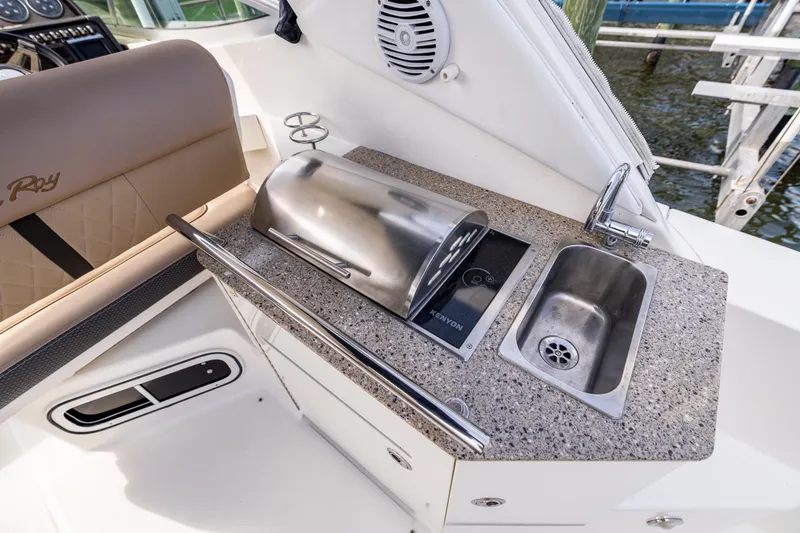 Slide: The Image of 2016 Sea Ray 310 Sundancer boat kitchenette with grill and sink. - 29